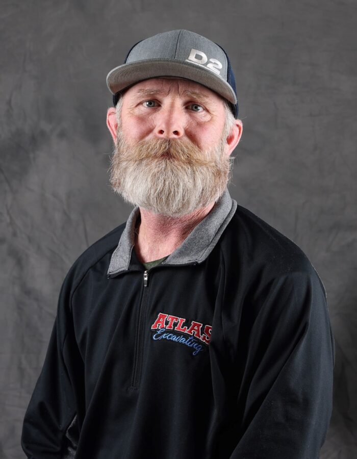 Bearded man in cap and Atlas jacket.