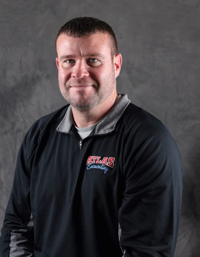 Man in black ATLAS pullover with short hair, beard.