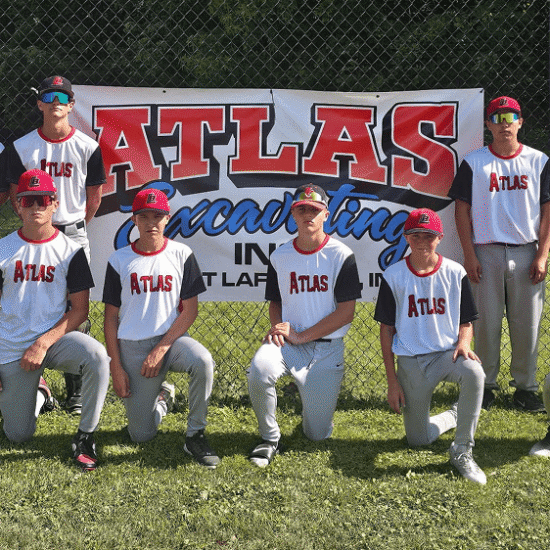 Six Atlas players pose by a banner; four kneeling, two standing.