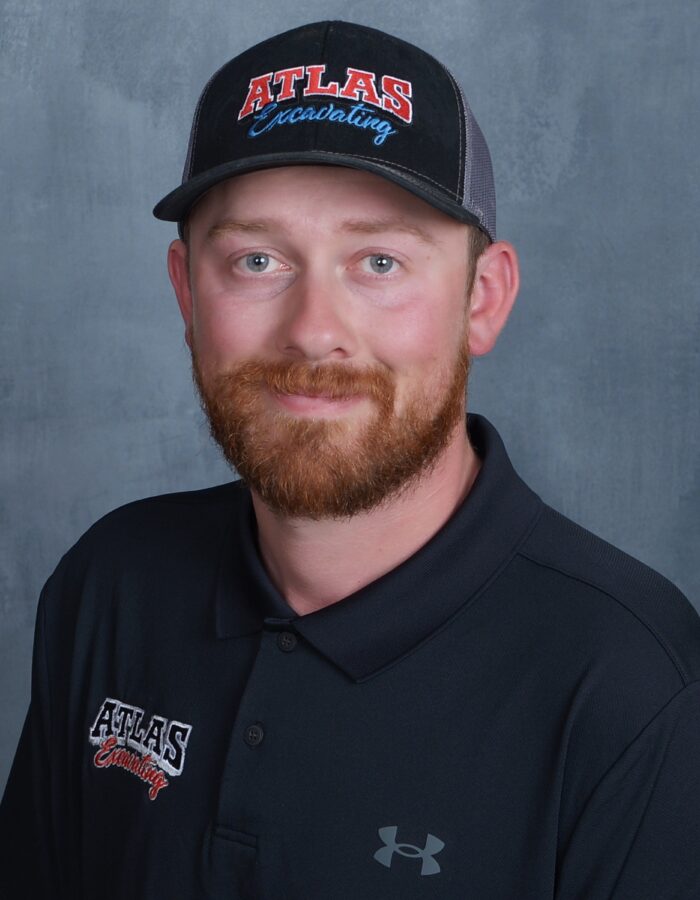 Man with reddish beard in black Atlas cap and polo.