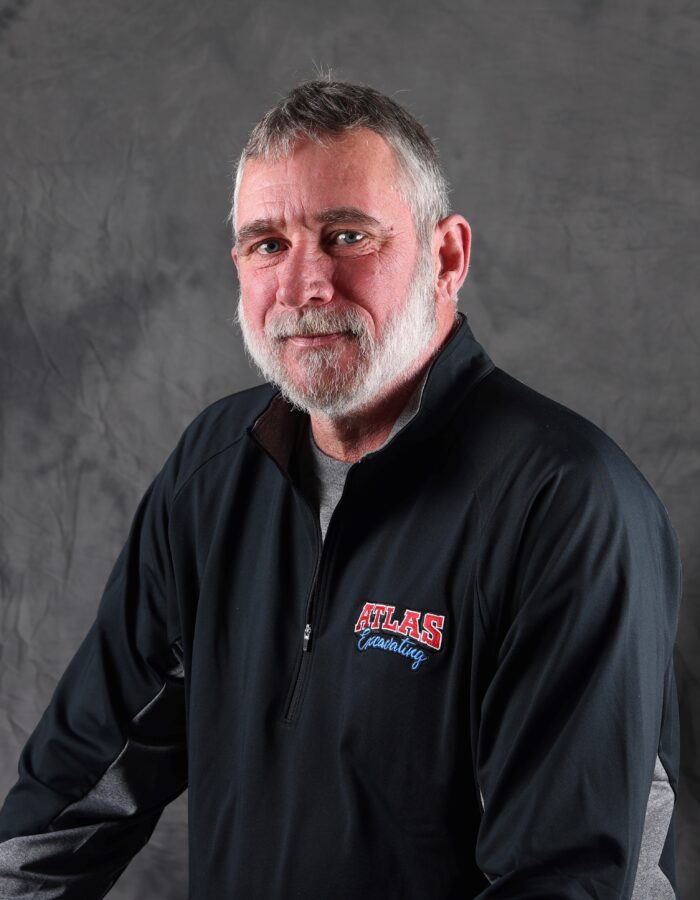 Middle-aged man with gray hair, beard, and Atlas jacket.