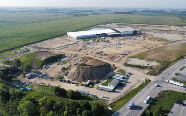 Aerial view of two white-roofed buildings at construction site.